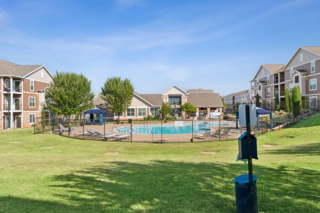 A sunny day at a residential complex with a swimming pool.