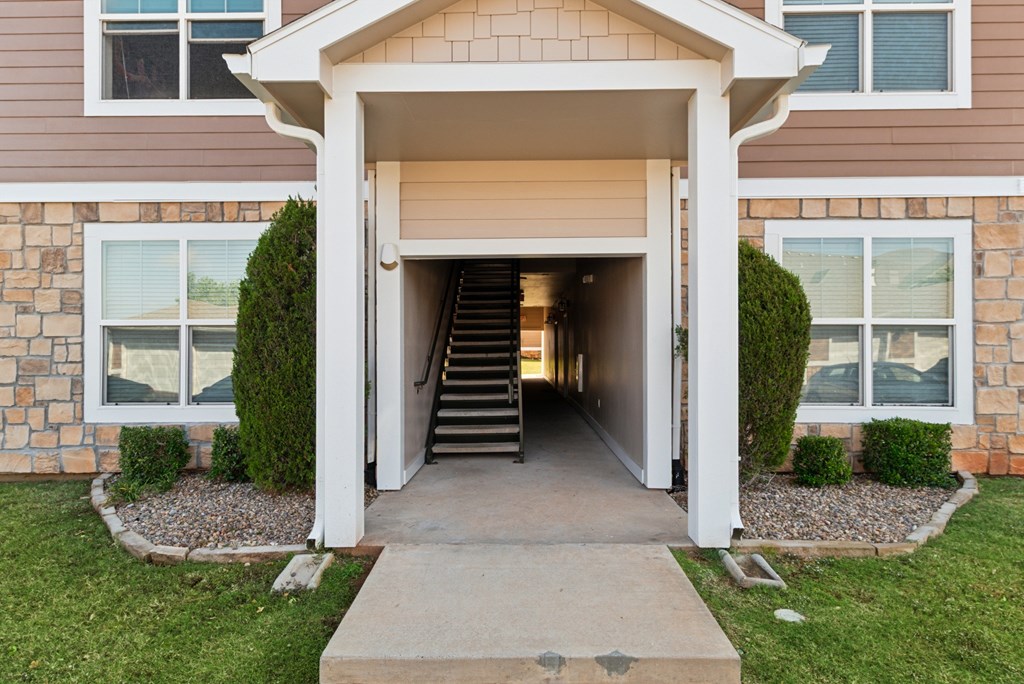 A house with a white doorway leading to a staircase.