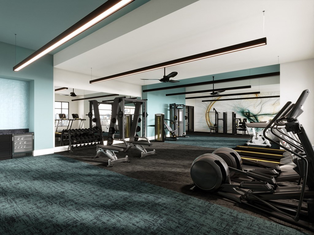 a gym with cardio equipment and a ceiling fan