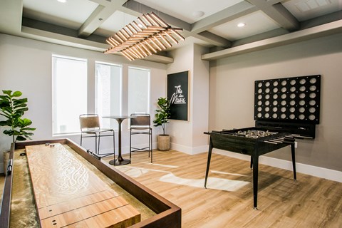 A shiny pool table is in the middle of a room with a billiard table.