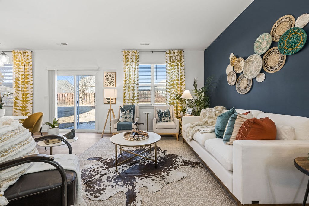 A living room with a white couch and a coffee table.