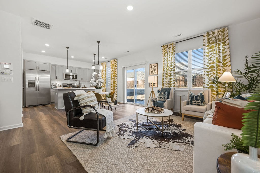 A modern kitchen with a dining area and a living room.