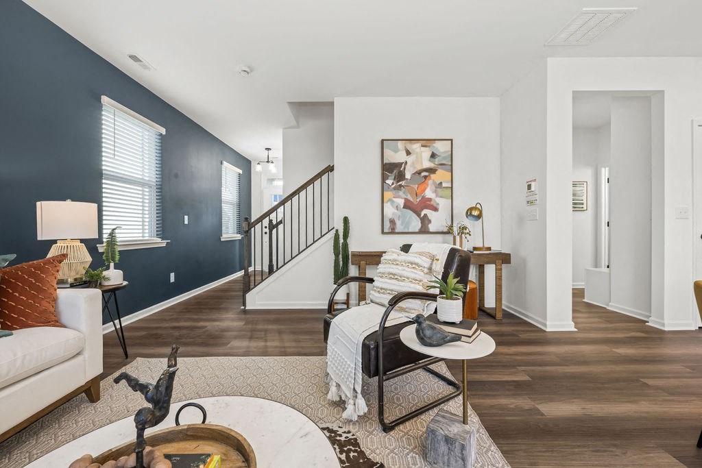 A living room with a white couch, a chair, and a coffee table.