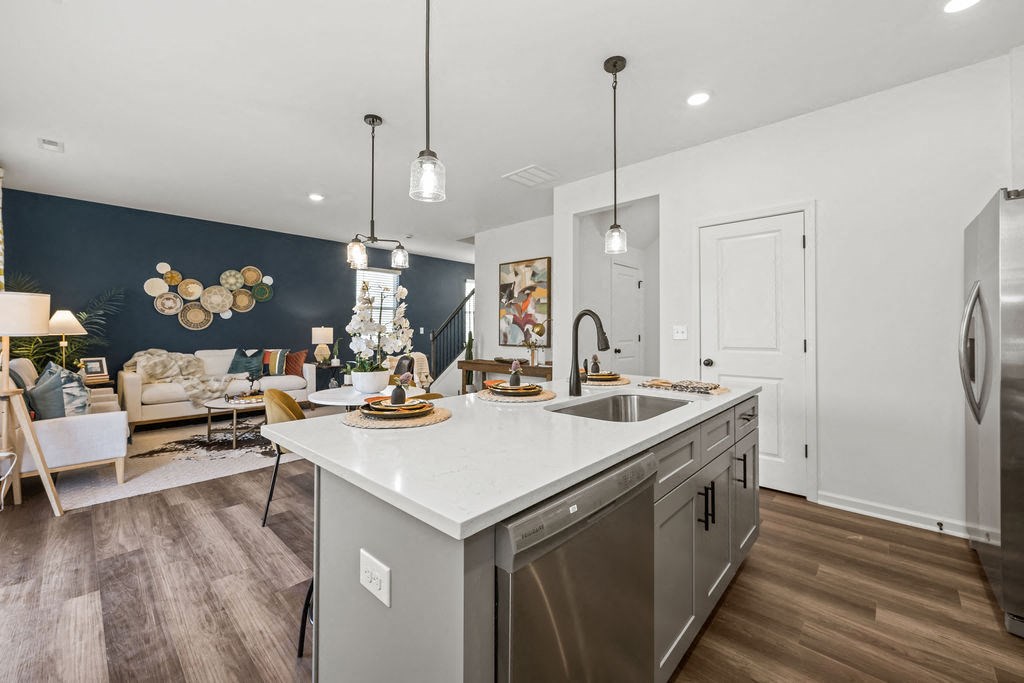 A modern kitchen with a large island and stainless steel appliances.