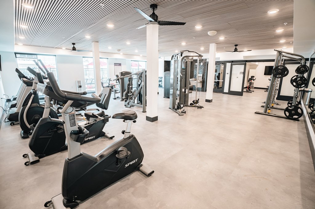fitness center with weight racks and cardio equipment