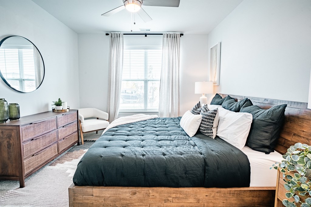 primary bedroom with large bed and large windows