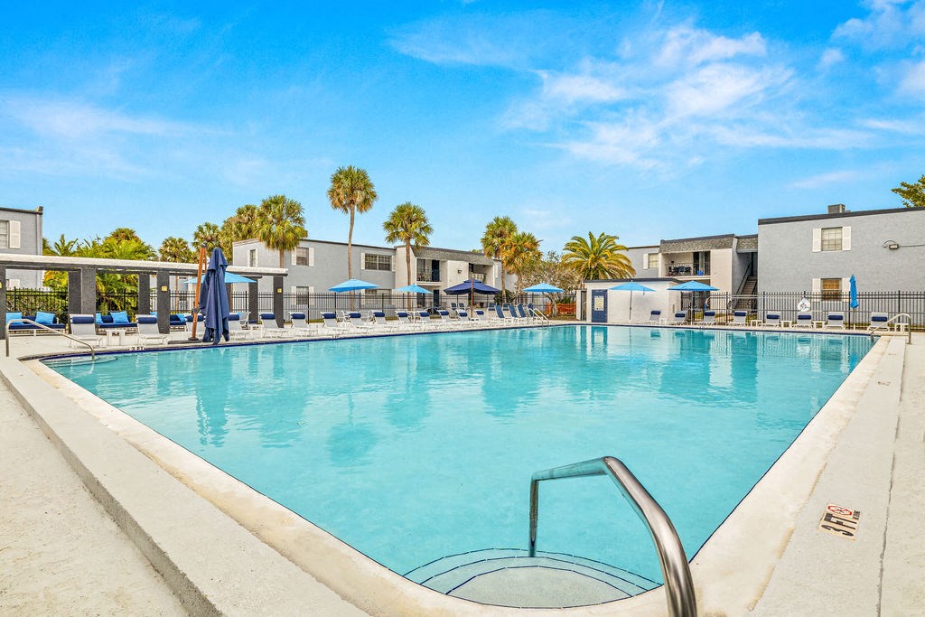 our resort style swimming pool is surrounded by our apartments and has palm trees