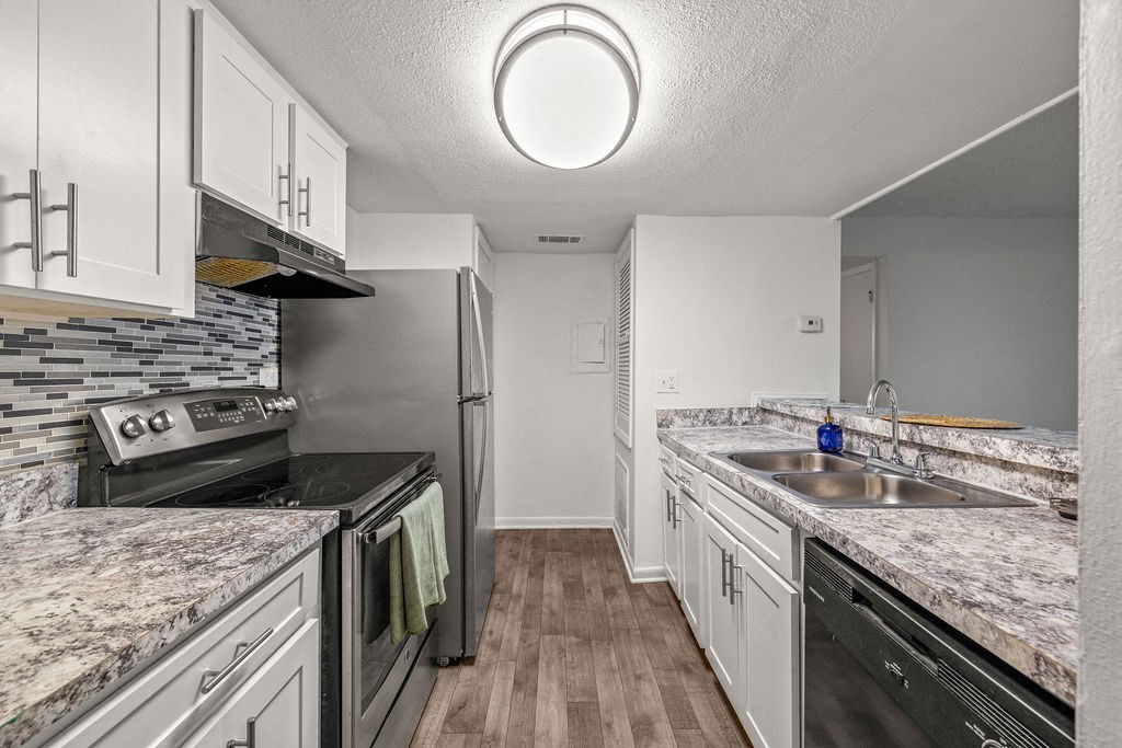 a kitchen with granite counter tops and stainless steel appliances