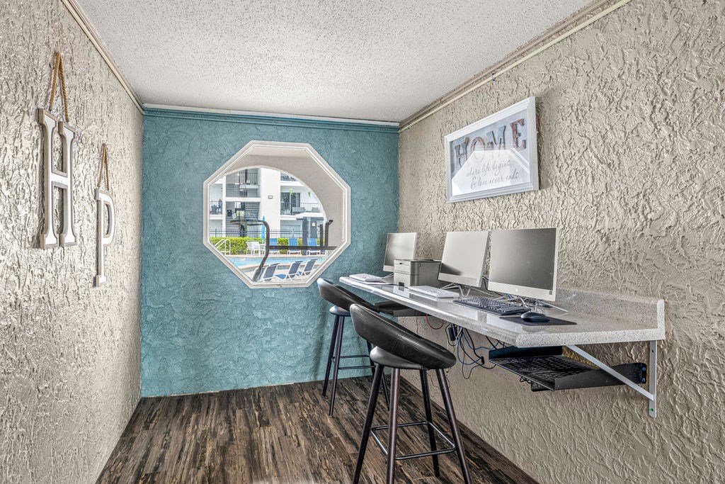 a home office with a desk and a window