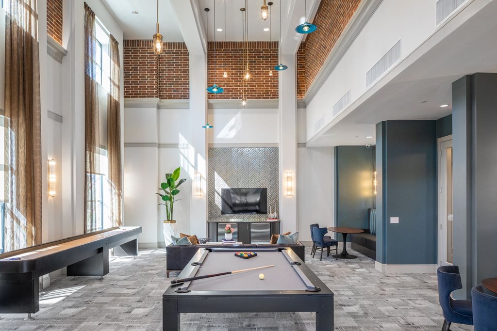 a clubhouse with a pool table and a fireplace