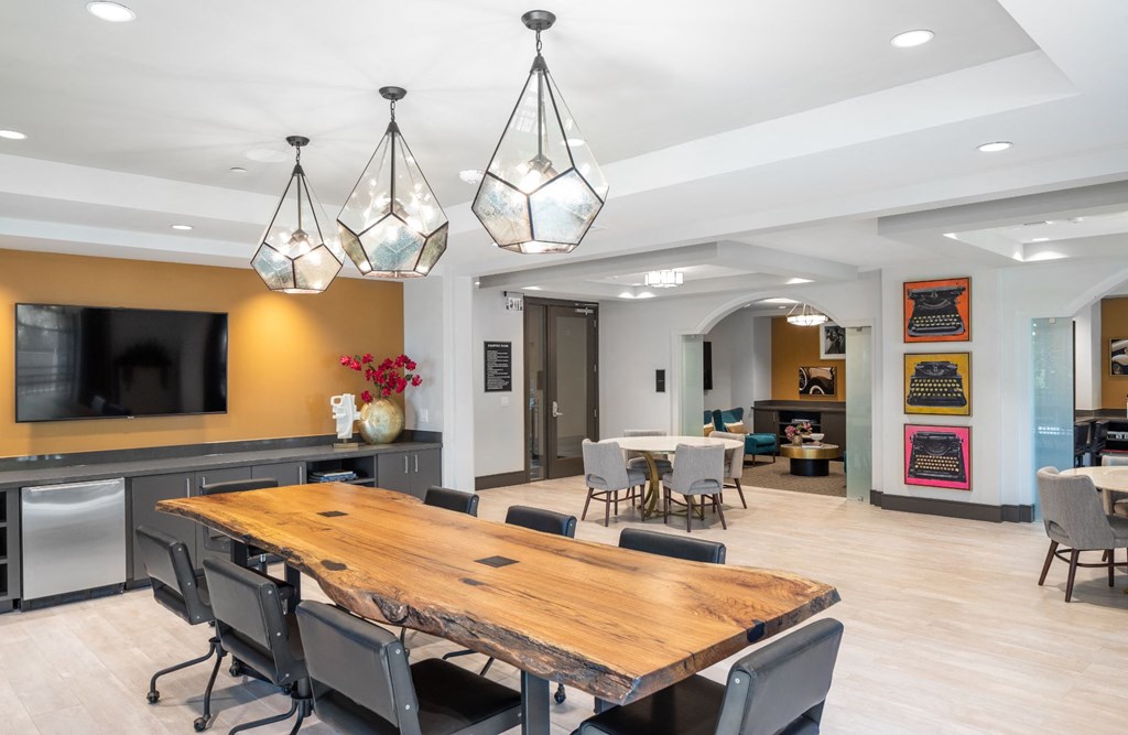 a conference room with a wooden table and chairs and a tv