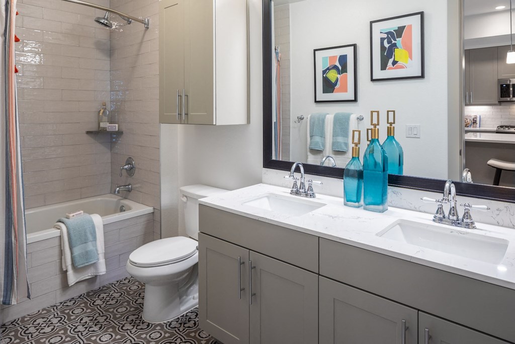 a bathroom with a sink and a toilet and a shower