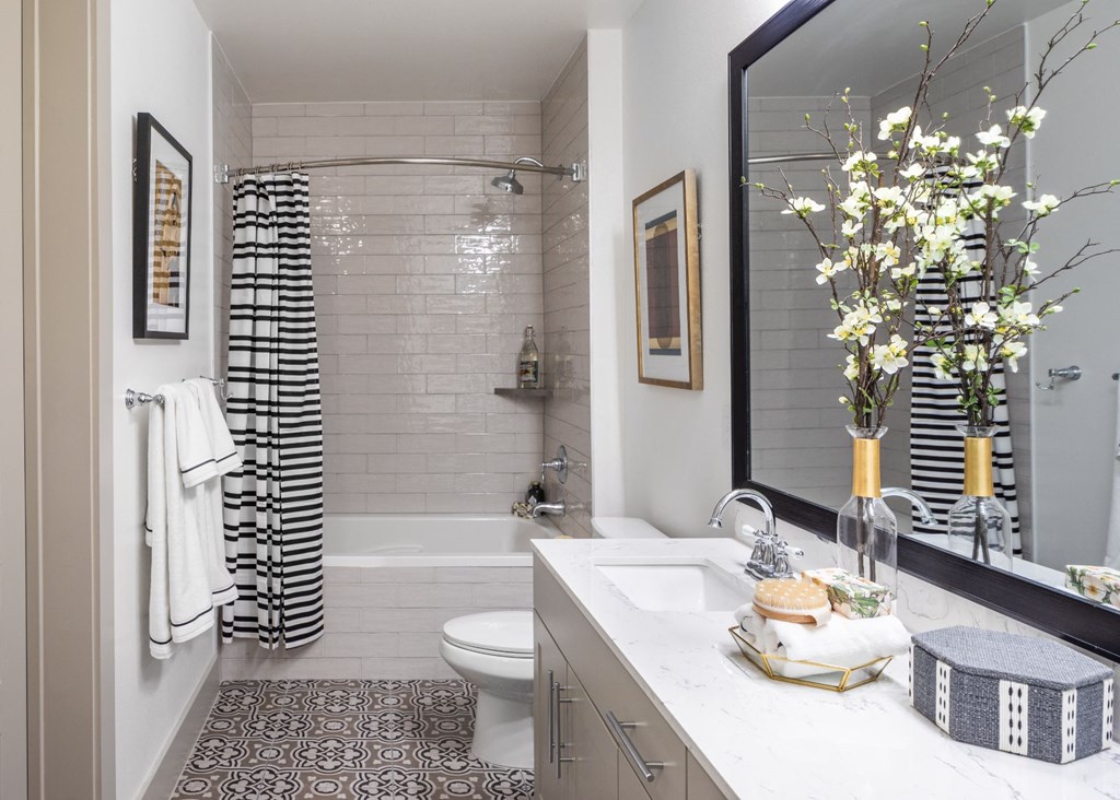 a bathroom with a shower and a sink and a mirror