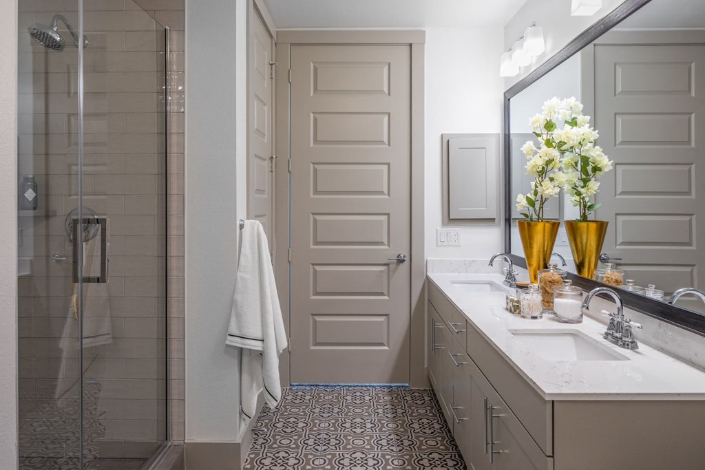 a bathroom with a shower and a sink and a mirror
