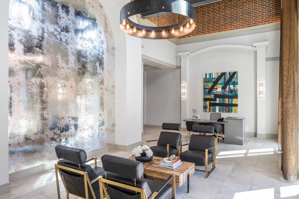 a lobby with chairs and tables and a large wall mural