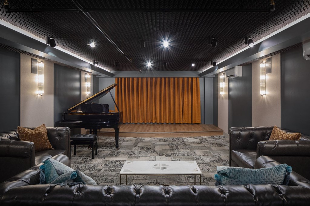 a living room with a stage and a piano