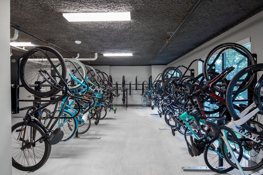 a row of bikes parked in a parking garage