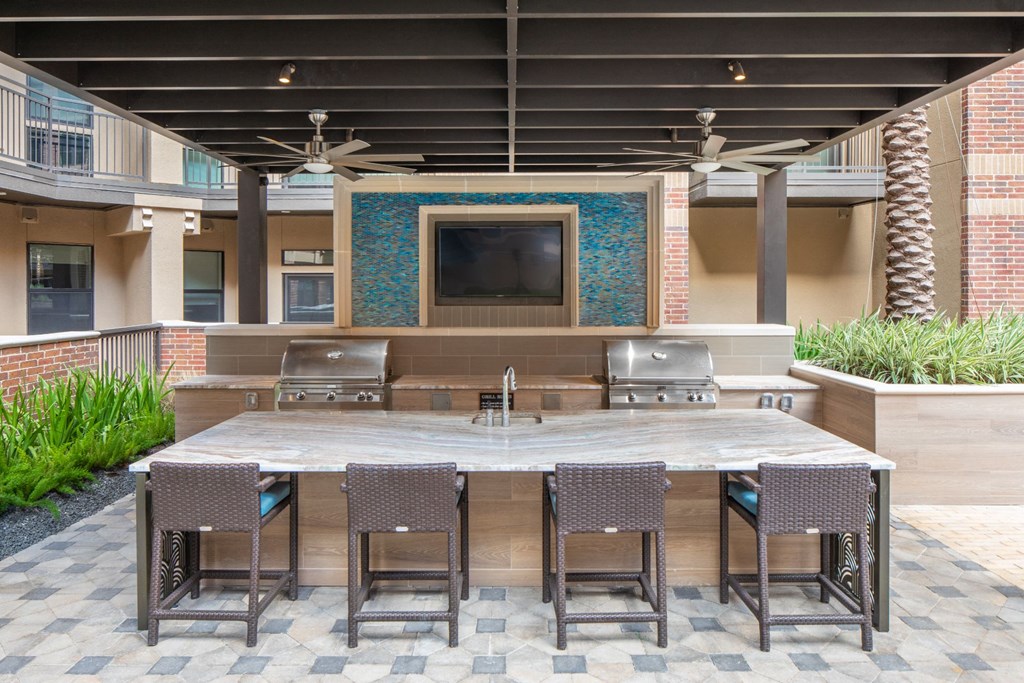 a patio with a table and chairs and a tv