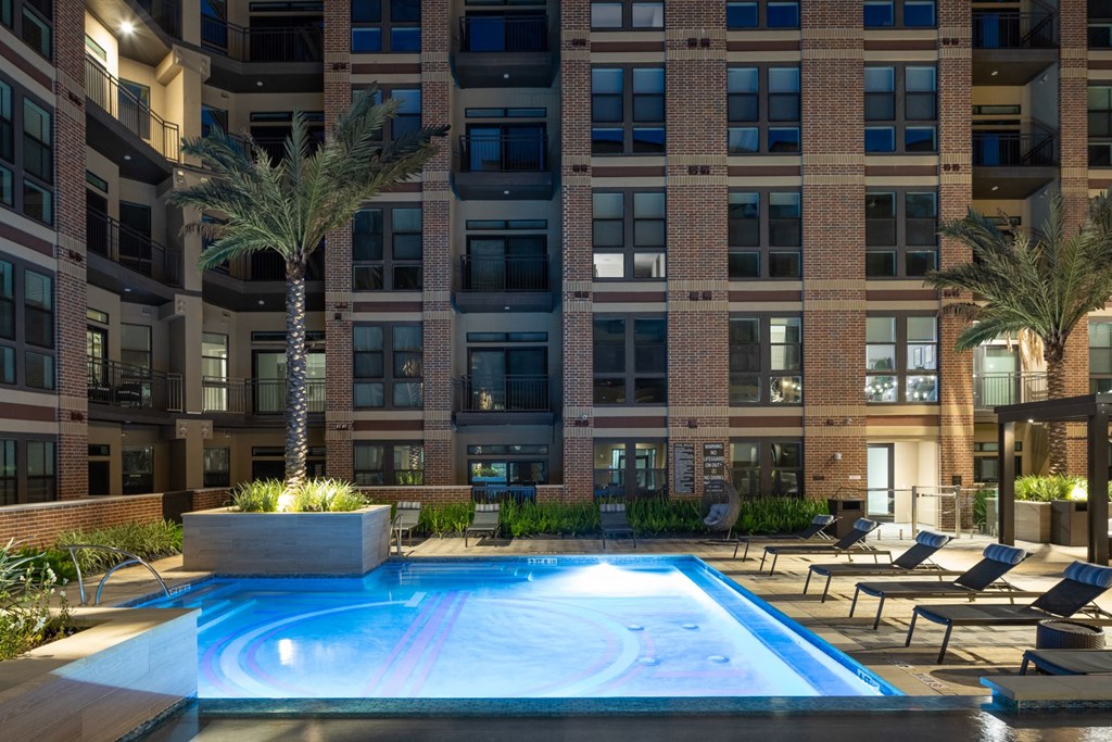 a swimming pool in front of a large building