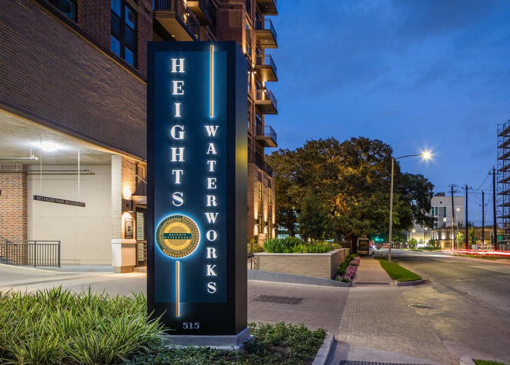 the facade of a hotel with a blue sign on the side of the street