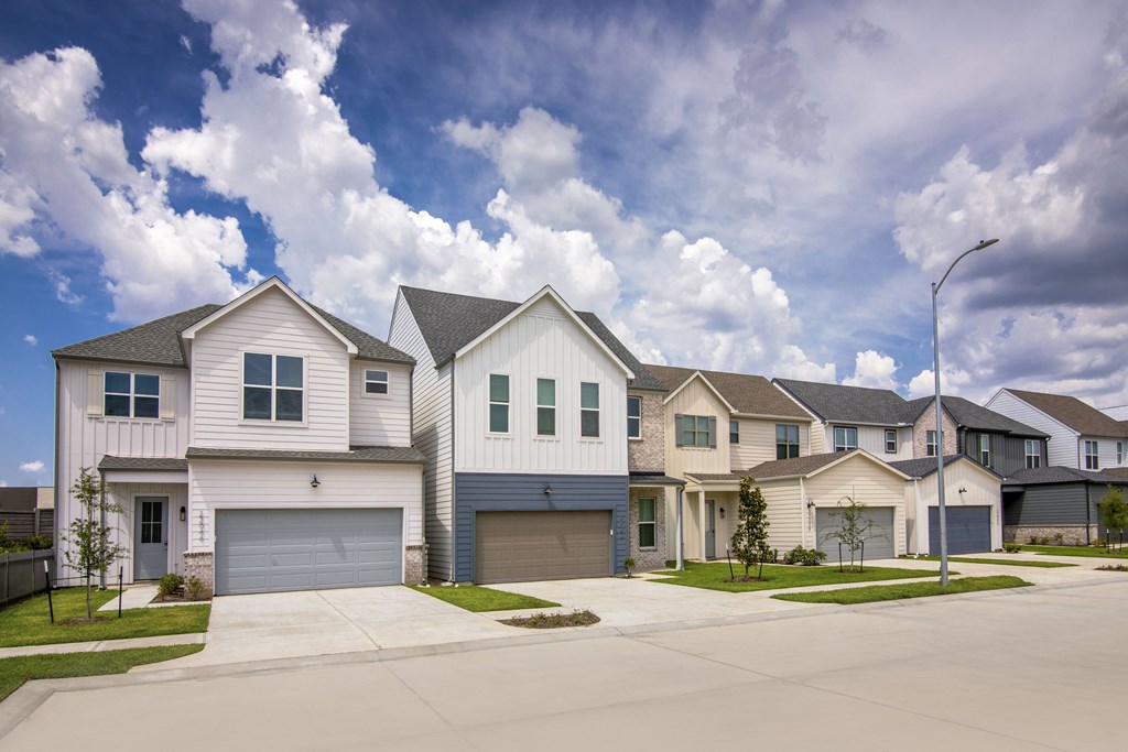 A row of houses with garages in front.