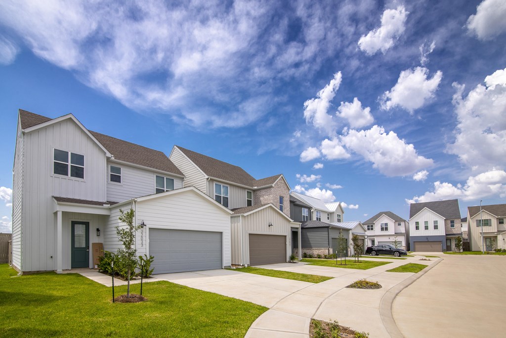 A row of houses with a clear blue sky above them.
