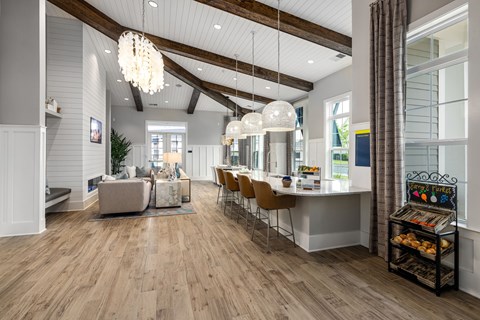 A modern kitchen with a dining area and a living room.