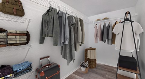 A room with a clothes rack and a suitcase.