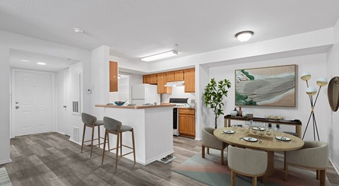 A modern kitchen with a dining table set for four.