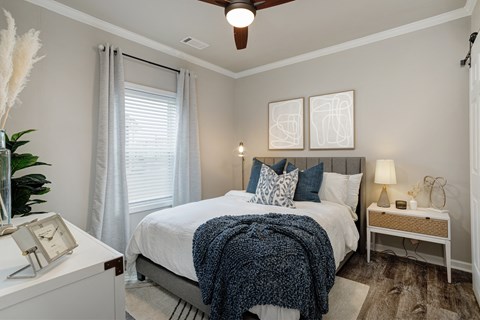 a bedroom with a large bed and a window
