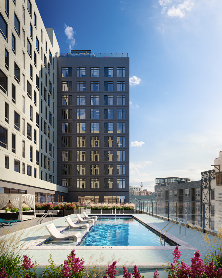 a swimming pool on the roof of a building in a city