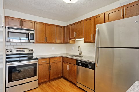 A kitchen with wooden cabinets and stainless steel appliances.