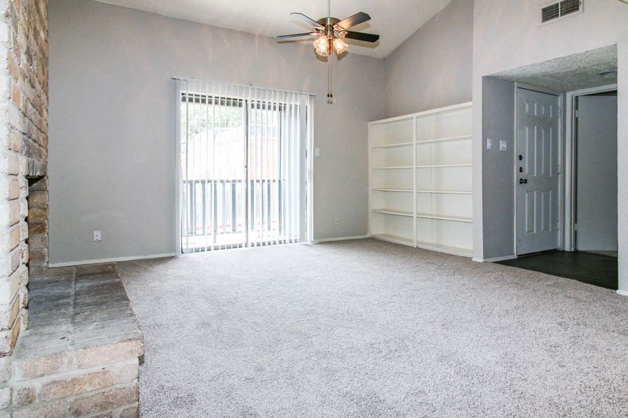 an empty room with two doors and a wall with mirrors