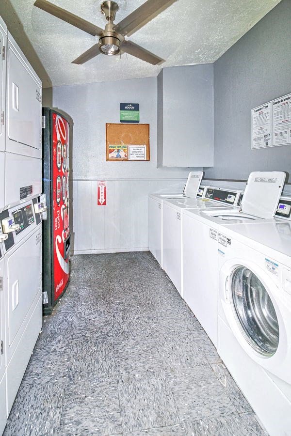 a laundry room with washing machines and a coke machine