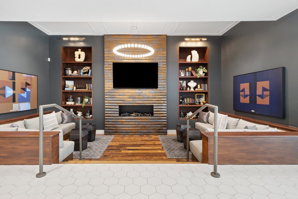 A modern living room with a fireplace and a television.