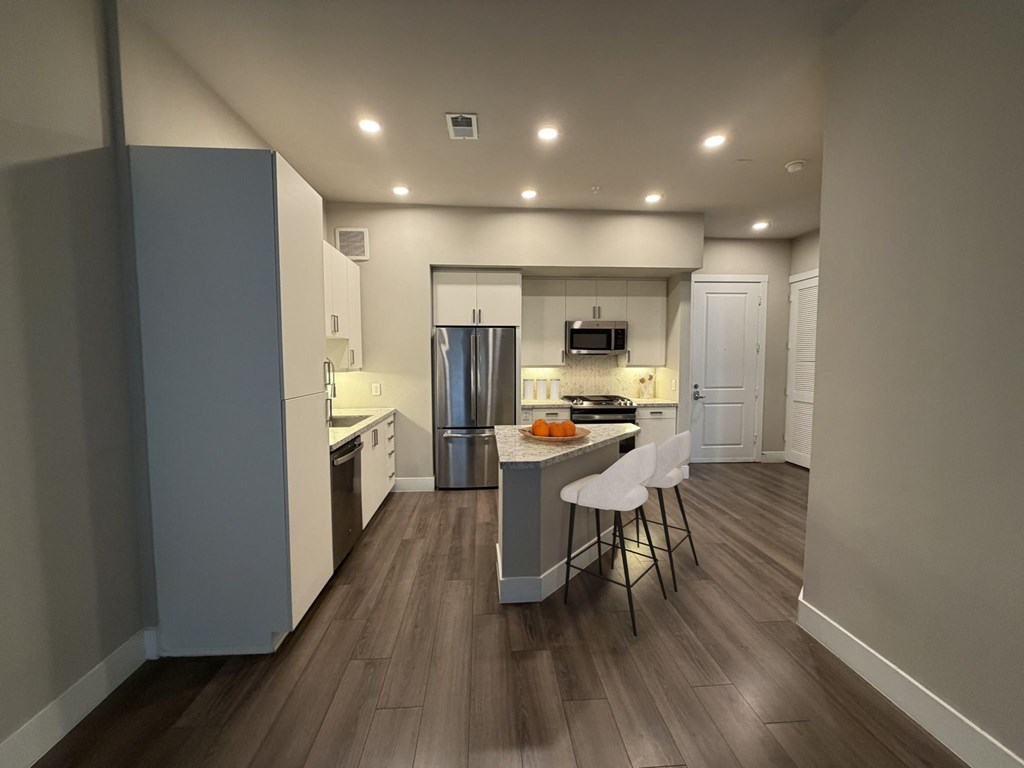 A kitchen with a table and chairs in the middle of the room.