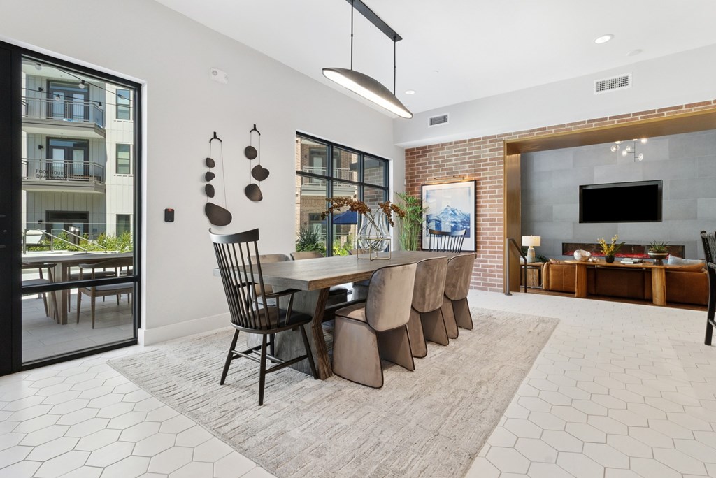 A modern dining room with a large table and chairs.