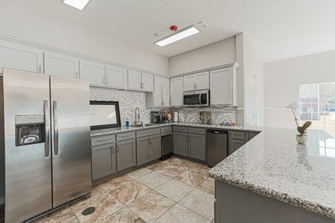 a kitchen with stainless steel appliances and granite counter tops