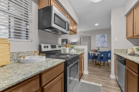 A kitchen with a stove top oven and microwave.