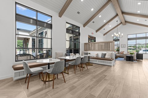 A modern dining room with a large table and chairs.