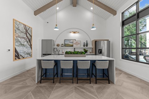 A kitchen with a table and chairs and a painting on the wall.