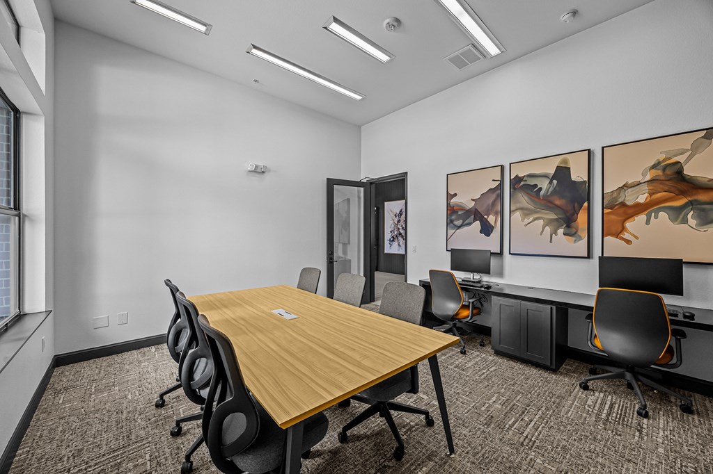 A conference room with a long table and chairs.