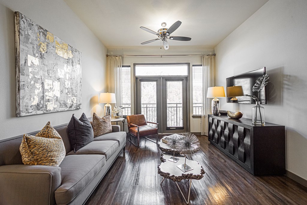 a living room with a couch and a ceiling fan