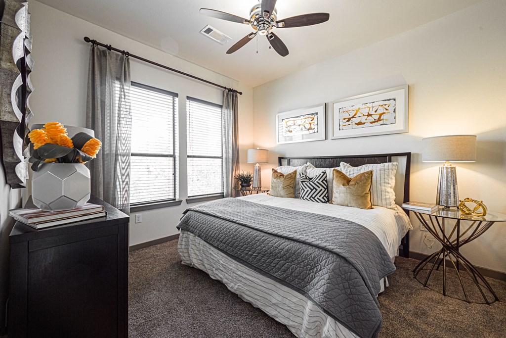 a bedroom with a large bed and a ceiling fan