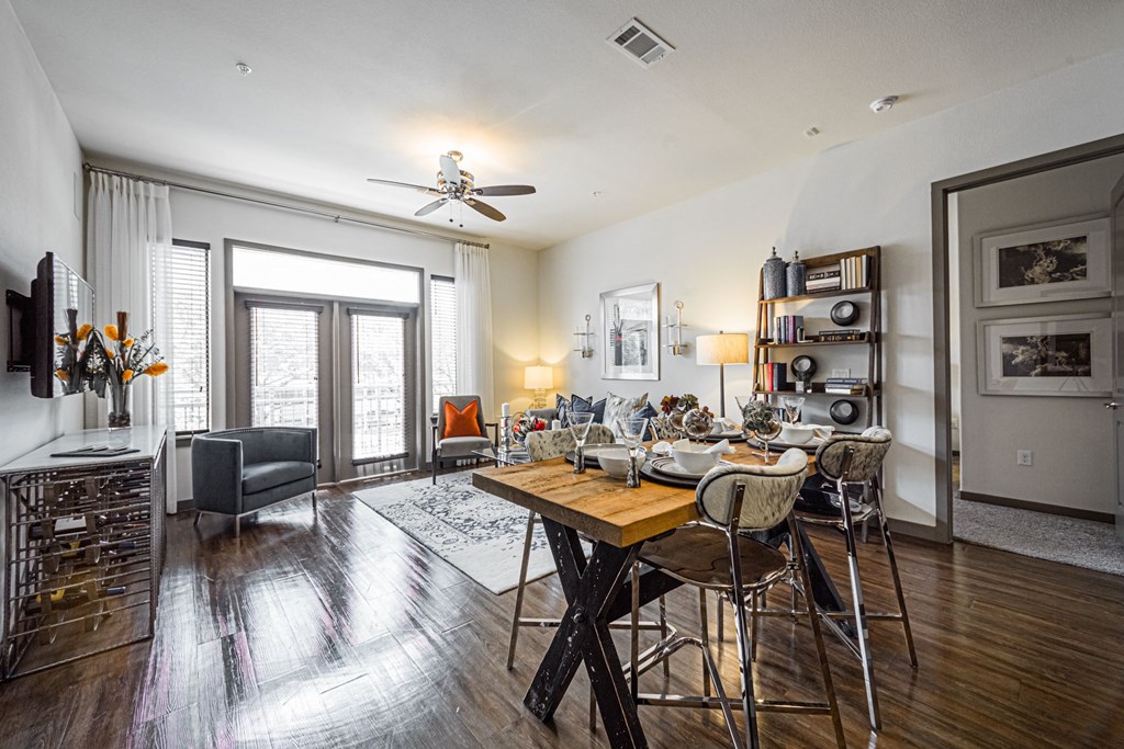 A modern dining room with a wooden table and chairs.