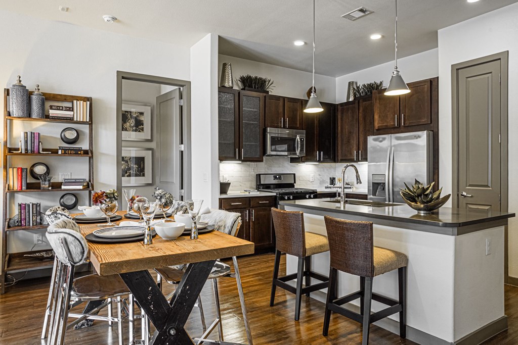 A modern kitchen with a dining table and chairs.