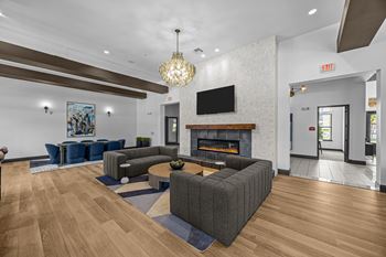 A modern living room with a fireplace and a television.