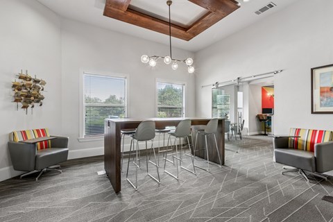 A modern dining room with a wooden table and grey chairs.