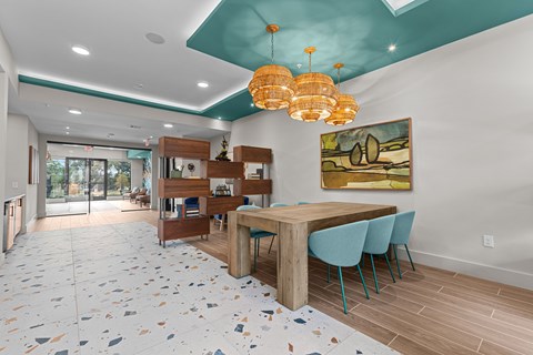 A dining room with a table and chairs.
