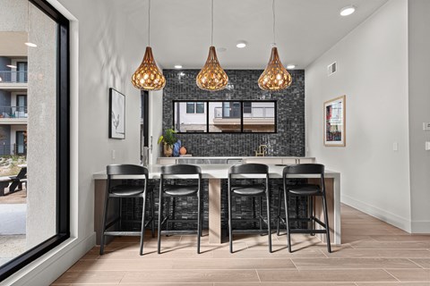 A kitchen with a table and chairs.